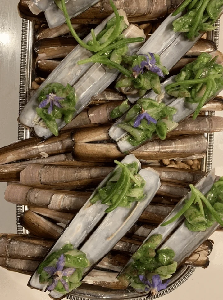 Razor clam appetiser with herb vinaigrette, prepared by Brown's Catering